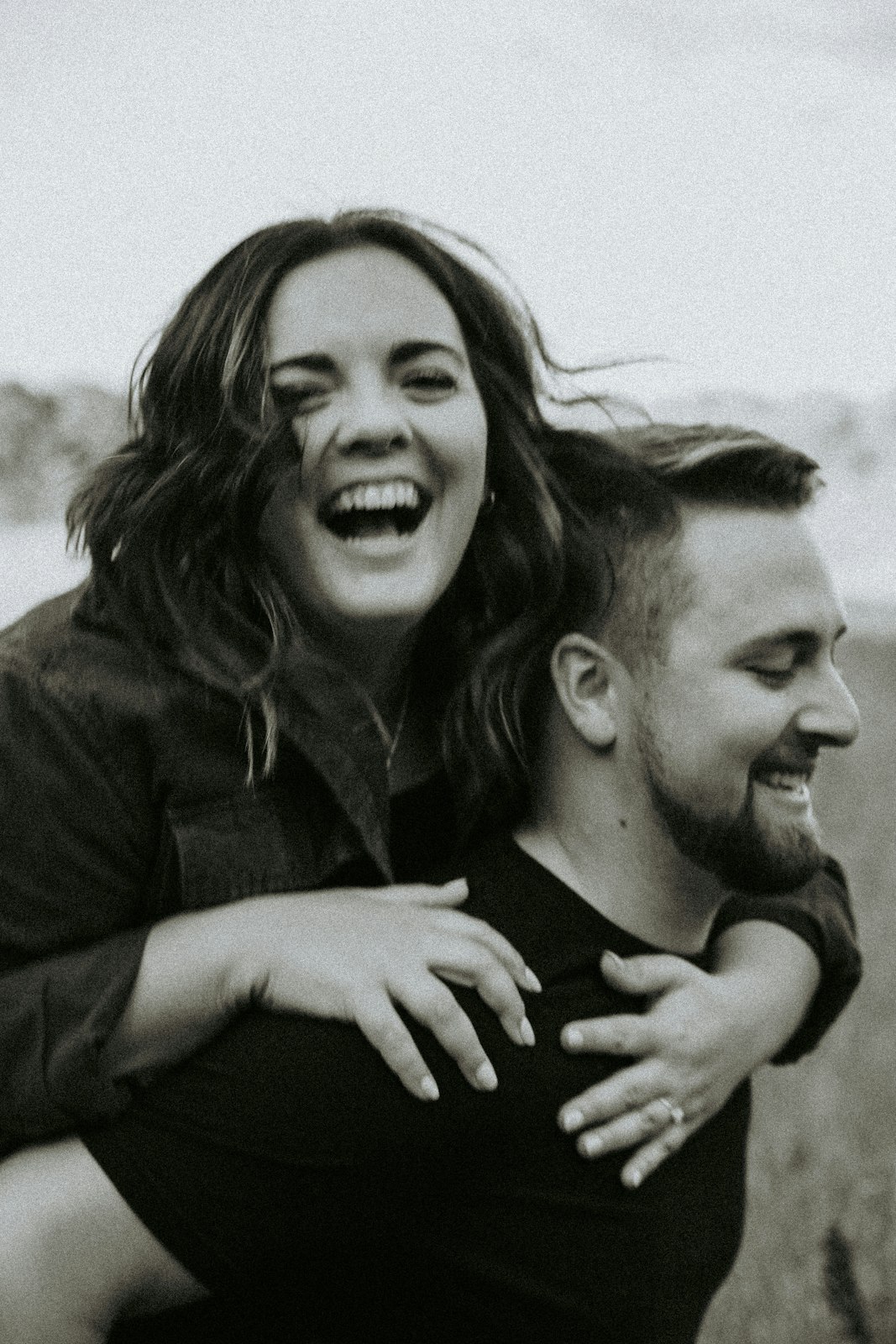 Nell and Rafa laughing in a field